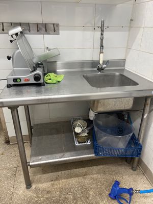 a kitchen with a sink and a mixer on the counter