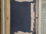 a picture of a chalk board in a frame on the floor