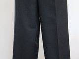 a mannequin wearing a black suit and tie on a mannequin stand
