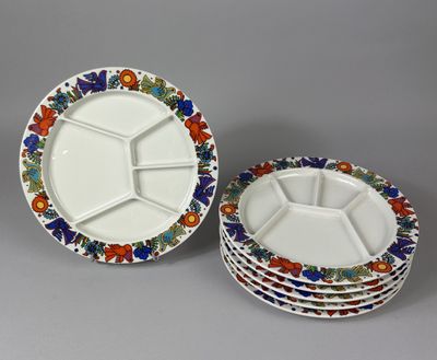 three plates with different designs on them sitting on a table