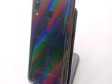 the back of a black phone with a rainbow - colored back