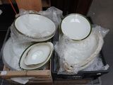 a lot of plates and bowls sitting in a box