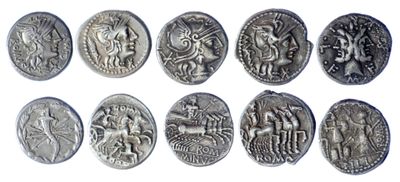 a close up of a bunch of silver coins on a white surface
