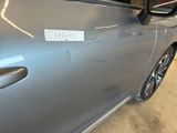 a car with a sticker on the side of it ' s door