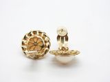 a pair of gold earrings with pearls on a white background