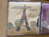 two pillows that have a picture of the eiffel tower on them