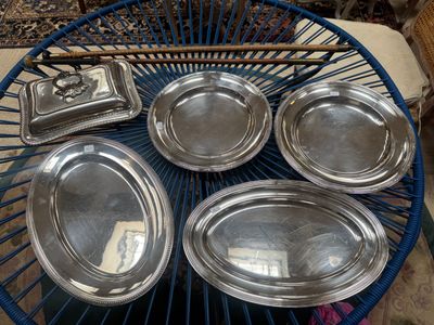 six silver trays on a blue wire table