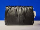 a black leather clutch bag sitting on top of a table