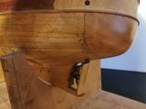 a wooden model of a boat sitting on a table