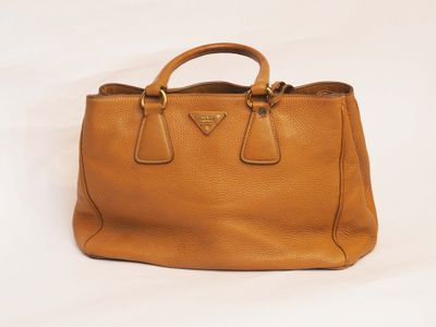 a brown leather handbag on a white background