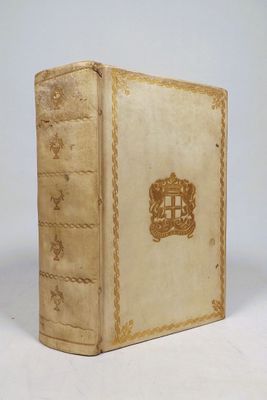 an old book sitting on top of a white table next to a white wall