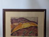 framed picture of a painting of a desert landscape in a wooden frame