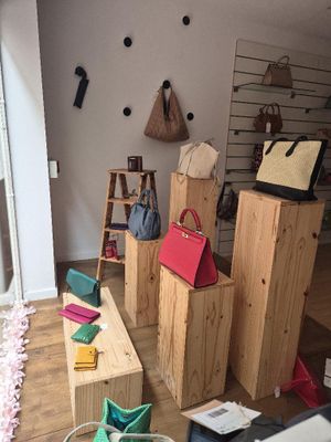 a room with a lot of handbags and bags on the floor