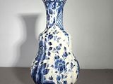 a blue and white vase sitting on a table