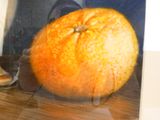 a picture of an orange that is on a table