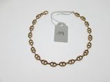 a close up of a chain bracelet with a price tag on it