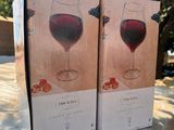 two boxes of wine sitting on top of a table next to each other