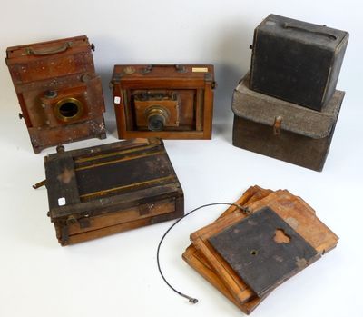 several old cameras are sitting on a white surface