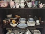 a china cabinet with a lot of dishes and cups on it