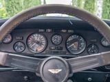 a steering wheel and dashboard of a car in a parking lot