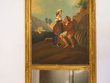 une photo d'un tableau accroché au mur au-dessus d'un miroir