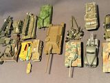 a lot of toy army vehicles that are on a table