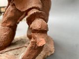a statue of an elephant that is standing on a rock