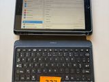 a tablet computer sitting on top of a laptop computer