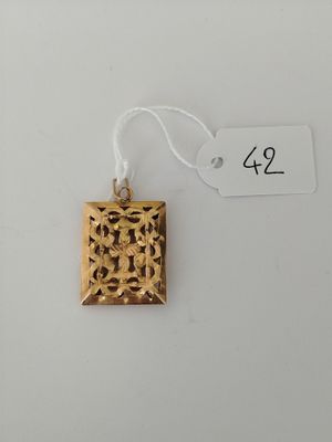 an image of a gold pendant on a white background