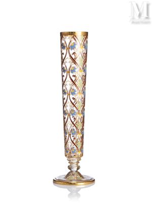 a tall glass vase with a floral design on it