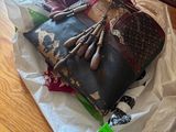 a pile of clothes and a purse on the floor