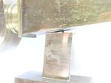 a close up of a metal object on a white surface