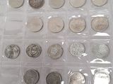 a lot of coins in a plastic box on a table