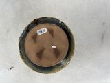 an overhead view of a brown vase with a label on it