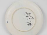 a white plate with writing on it on a table