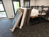 a pile of furniture in a room with a large window