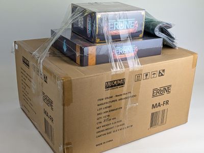 a stack of books wrapped in plastic on top of a cardboard box