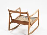 a wooden rocking chair with a wooden seat on a white background