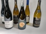 several bottles of wine are lined up on a white surface