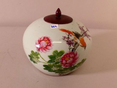 a white vase with a bird and flowers painted on it