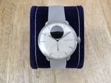 une montre posée sur un bracelet bleu et blanc