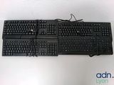 two keyboards sitting on top of each other on a table