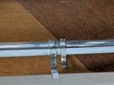 a close up of a metal pipe on a wooden table