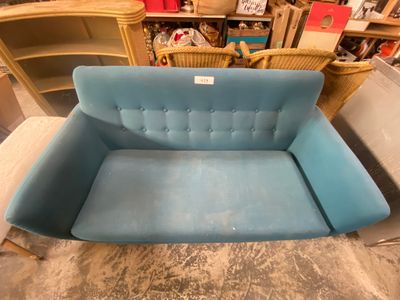 a blue couch that is sitting in a room