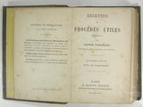 an old book opened to reveal a page of text on a white surface