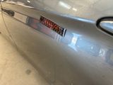 a close up of a car ' s door handle with a sticker on it