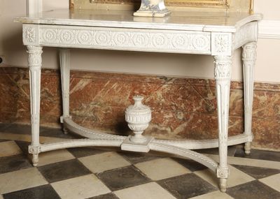 a white table with a mirror and a vase on it