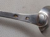 a spoon with a hole in the middle of it