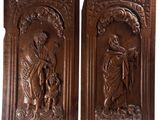 a pair of carved wood panels depicting jesus and the child jesus