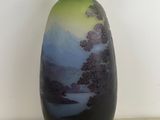 a vase that is sitting on a table in front of a white wall